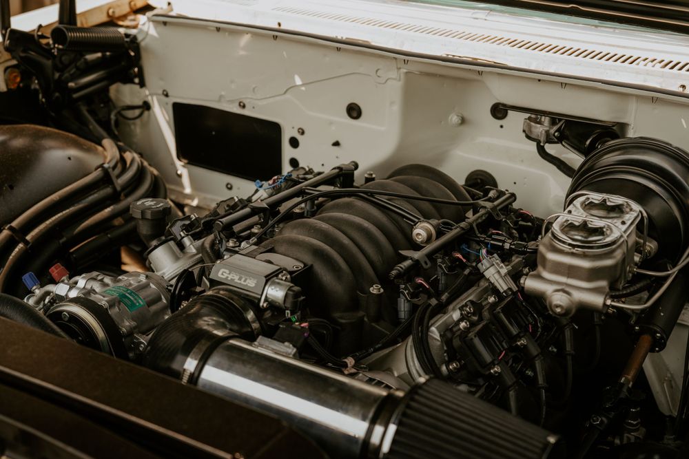 Close-up view of a custom car engine bay showing performance modifications and mechanical components.