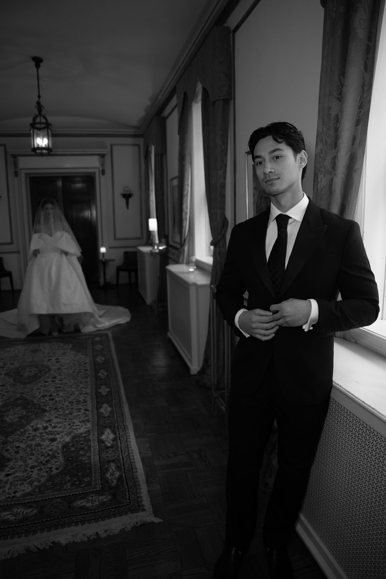 A formal hallway scene with elegant decor and a wedding dress visible in the background.
