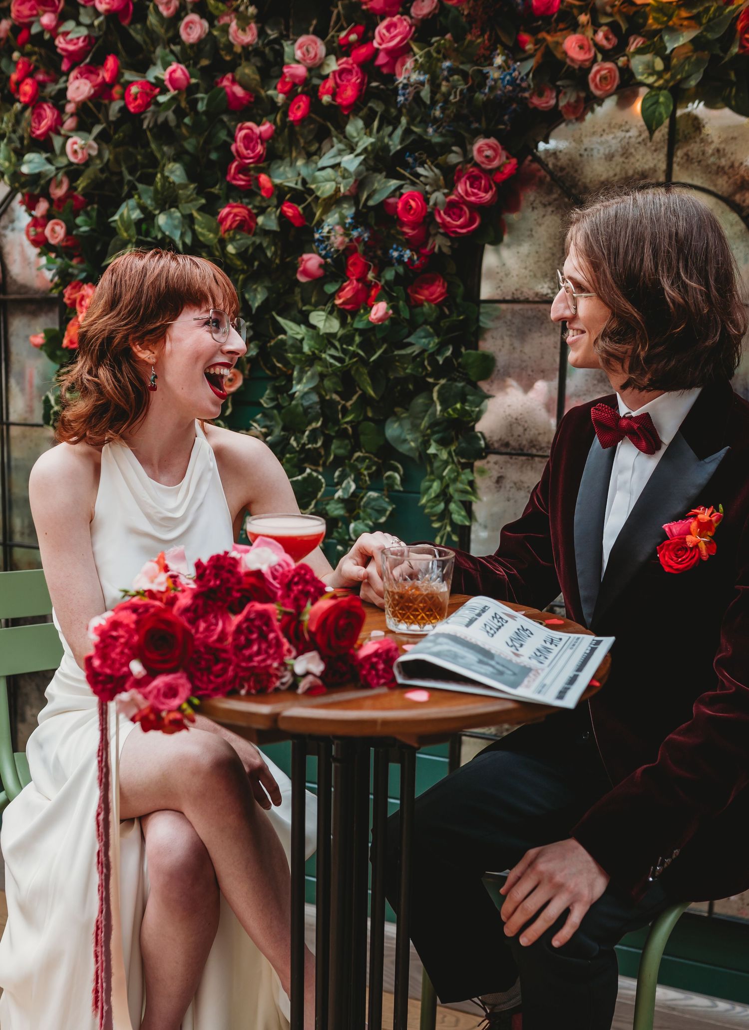 Photographers capturing moments during a wedding preparation session in a bright indoor setting.