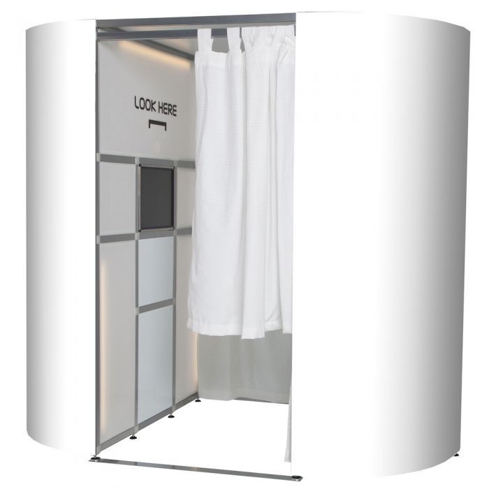 A modern white photo booth setup with curtain and lighting visible from the front entrance showing interior. instant print Photo Booth