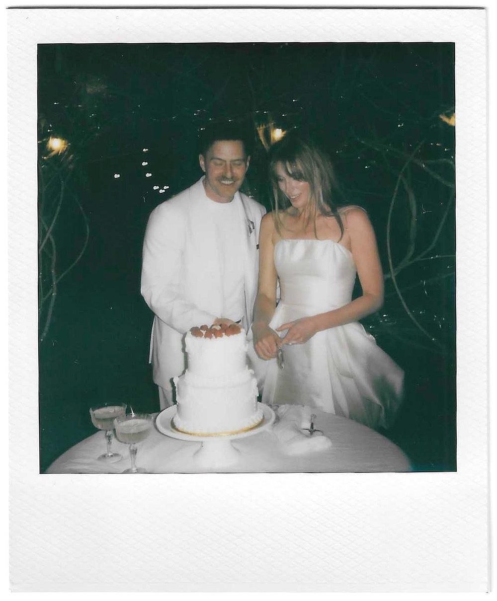 A polaroid of a couple cuts their white wedding cake together captured by Danielle Conner Photography in Carmel Valley, Ca.