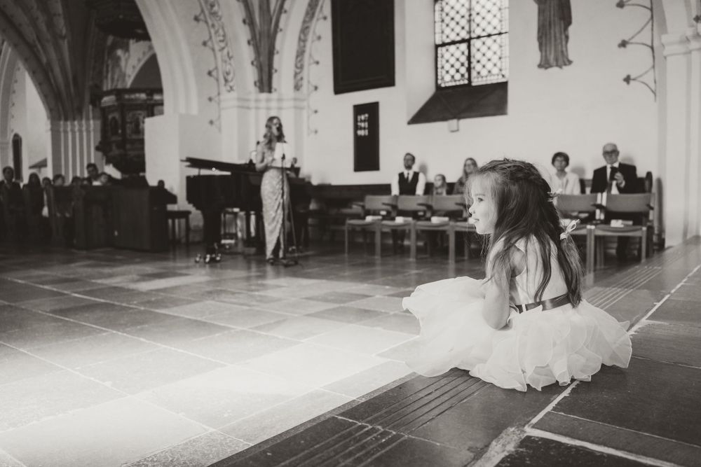 Black and white photo of wedding celebration in historic church interior.