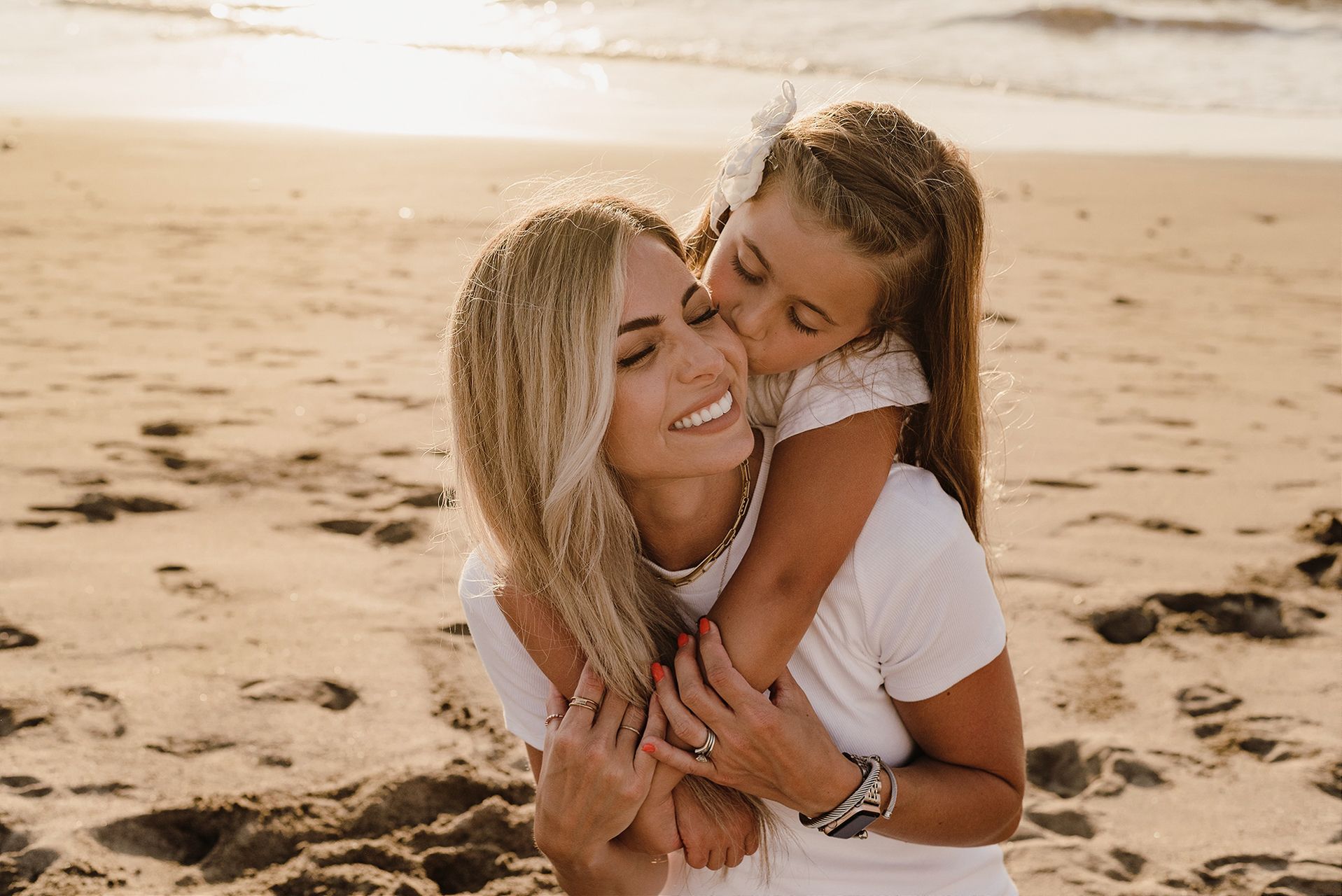 A joyful embrace captured on the beach at sunset.