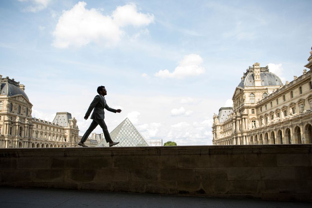 Professional solo traveler photoshoot at the Louvre Pyramid  by Picmytrip Paris.