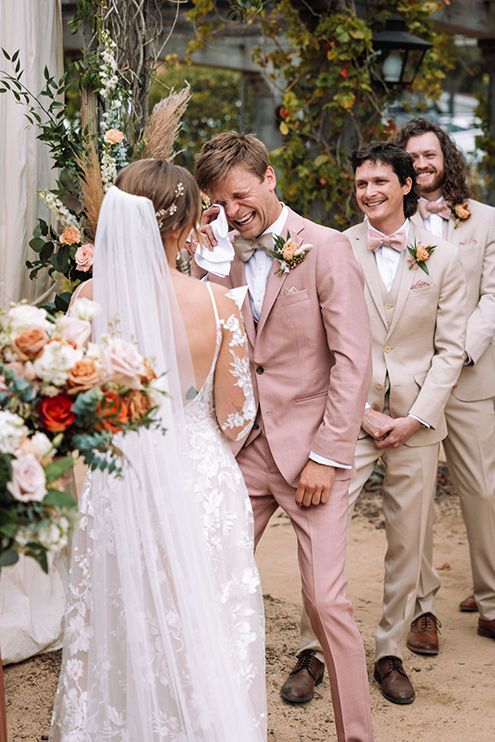Groom happy cries as his wife reads her vows during a wedding ceremony.