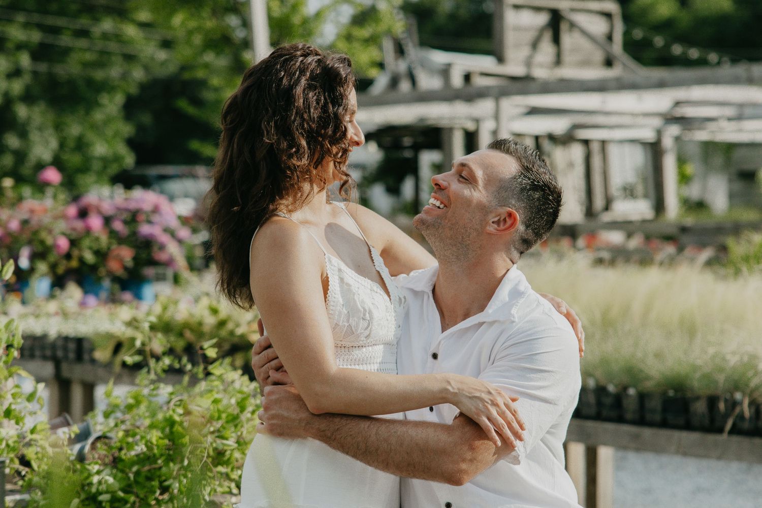 A tender embrace captured in a blooming garden setting.