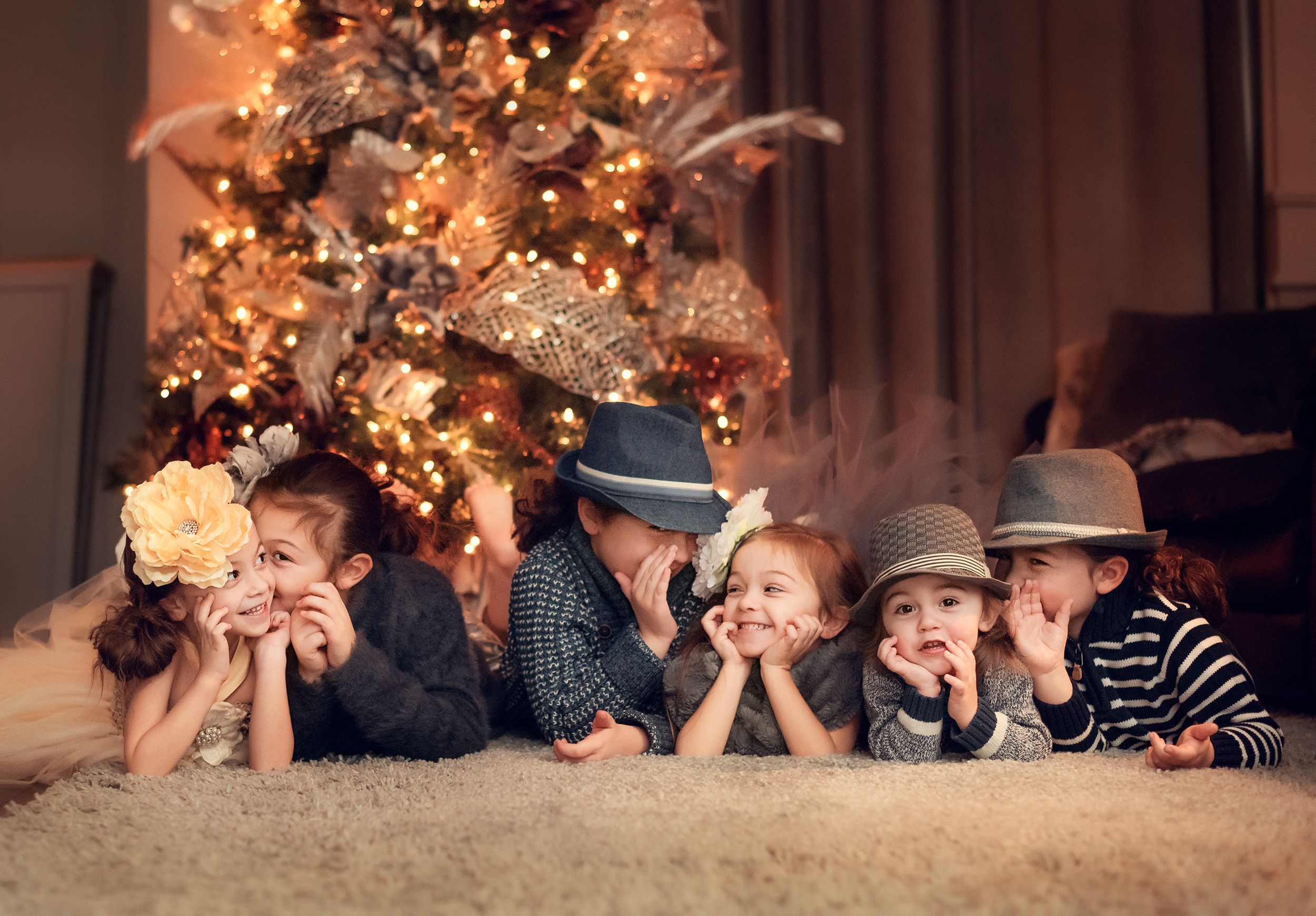 large family kids photo session at home with the Christmas tree using a flash light in Kleinburg, Ontario