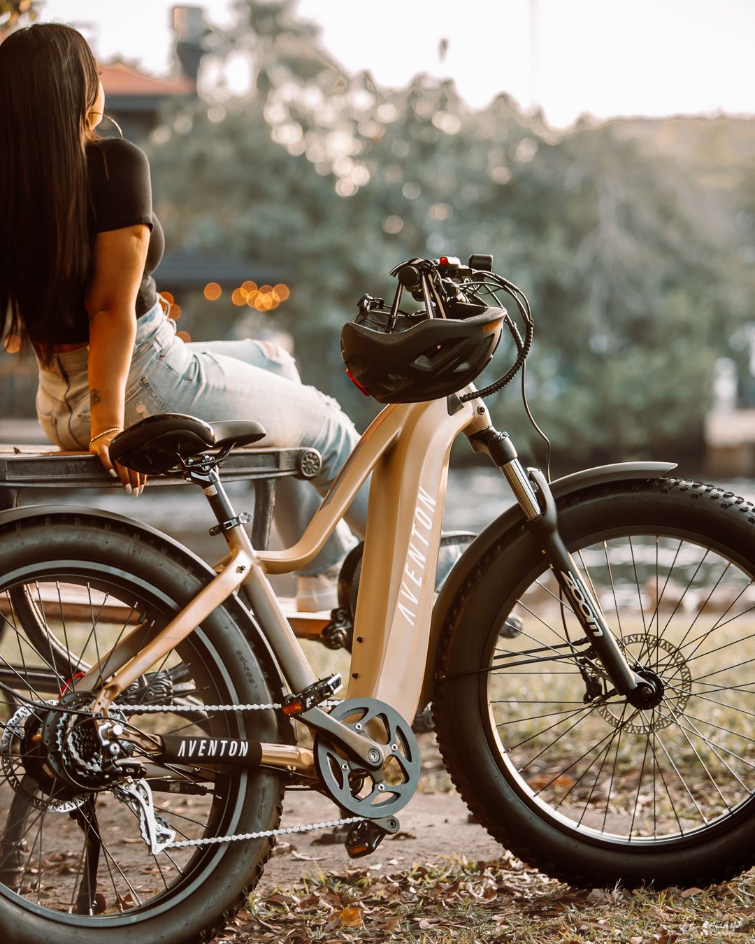 Electric bike parked at sunset with rider sitting on seat enjoying the view.