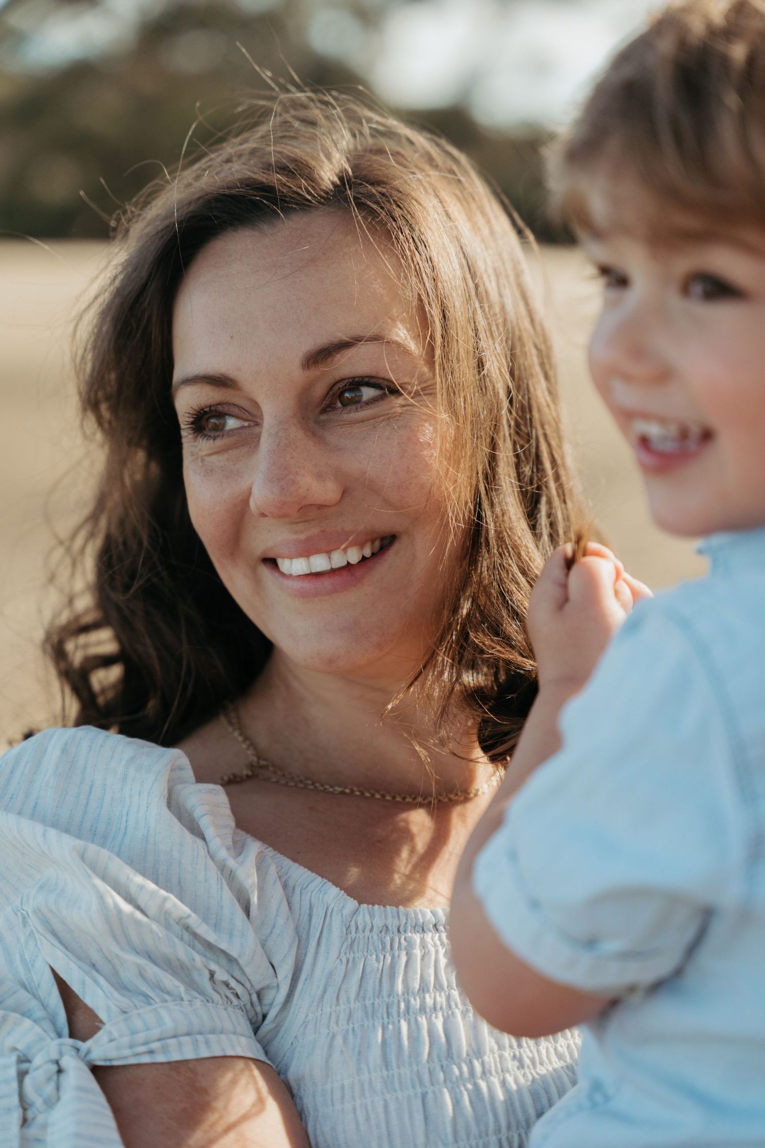 A joyful moment captured outdoors showing warmth and connection in natural lighting.