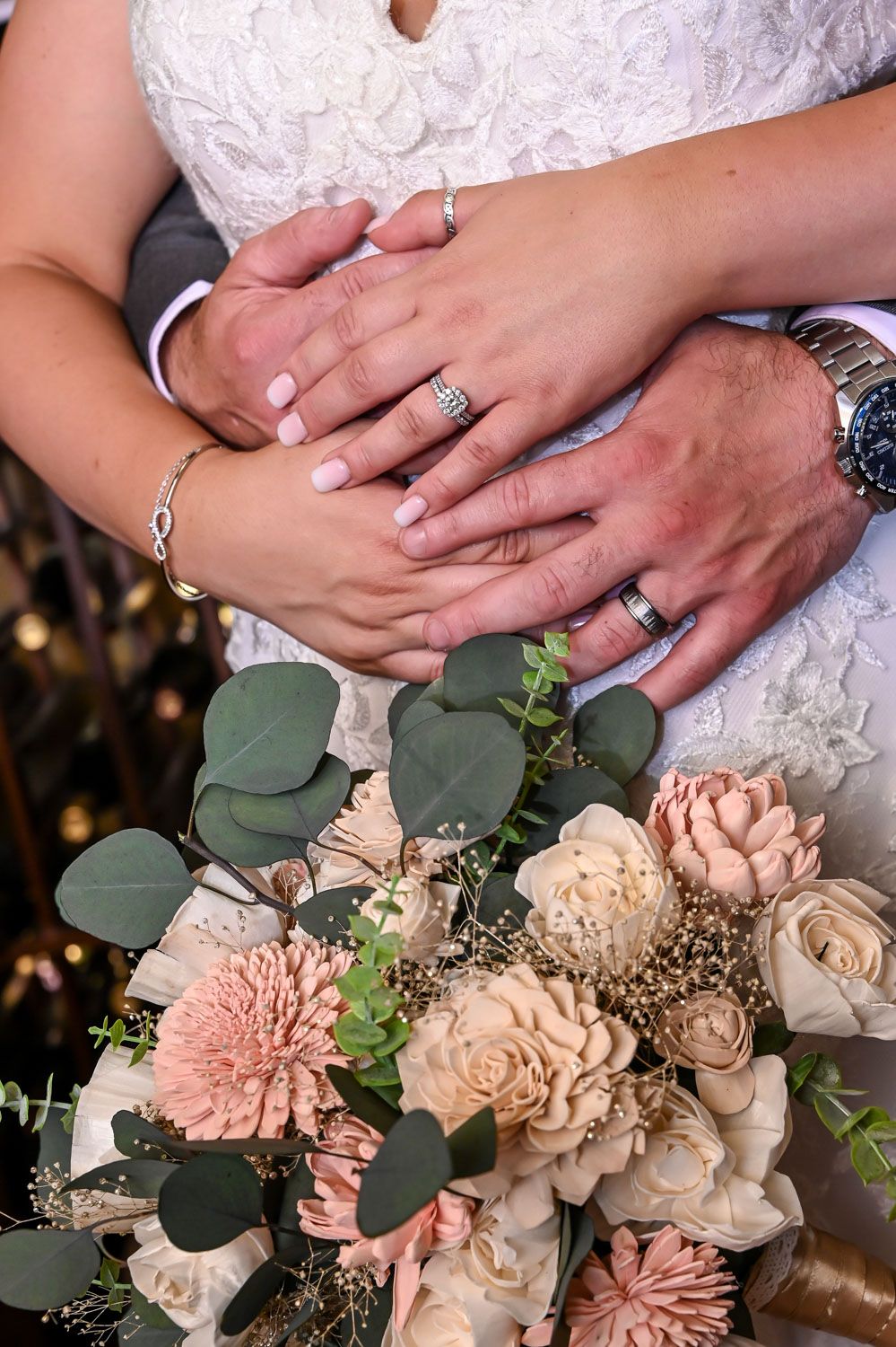 Wedding photo of couple's rings and flowers.