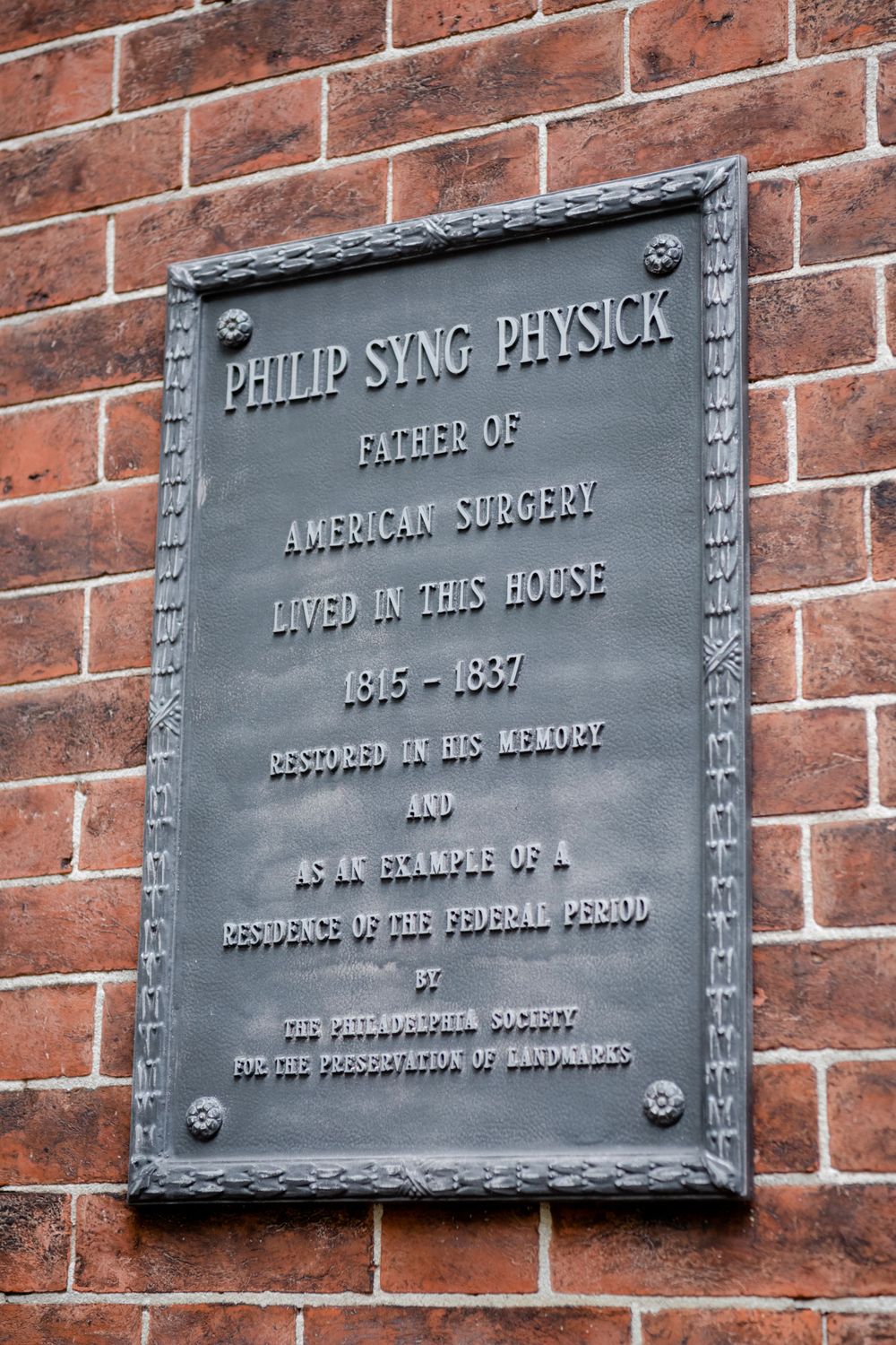 Historical plaque on brick wall commemorating Philip Syng Physick as Father of American Surgery at his former residence 1815-1837.