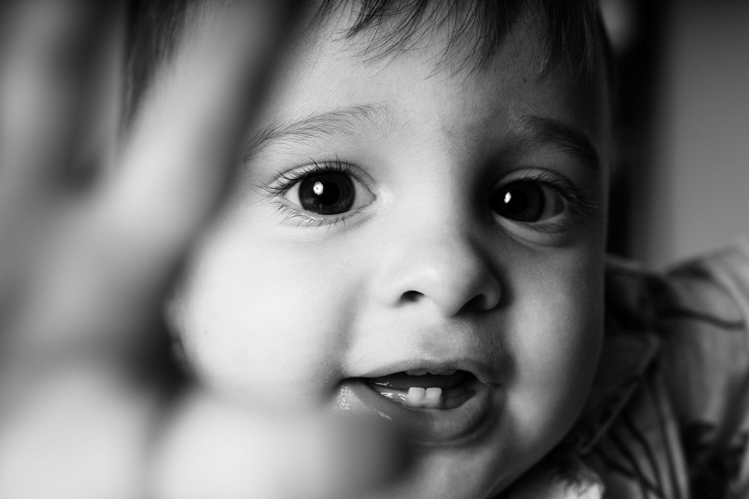 Series of black and white close-up shots showing expressive eyes and smiles.