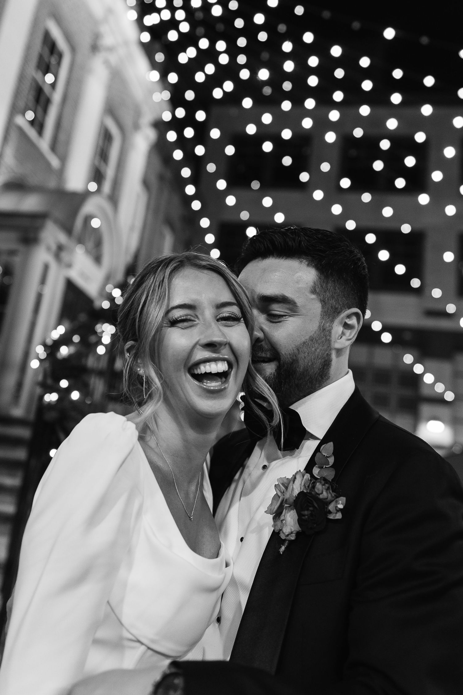 Luxury black tie wedding in central London at Christmas. Fun and laughter candid couple moment by London Wedding Photographer