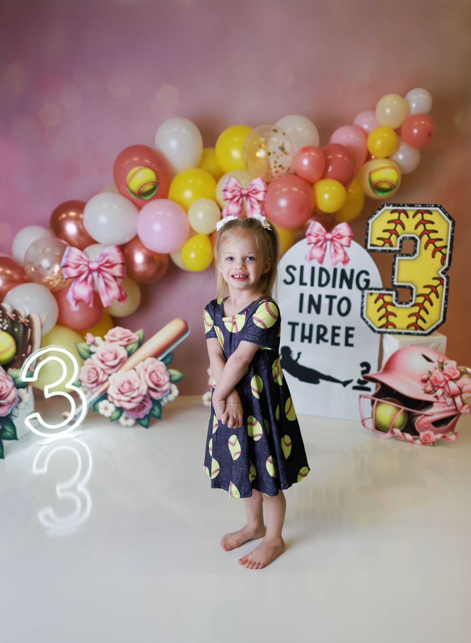 Studio portrait with pink and white rainbow backdrop and vintage-inspired decor.
