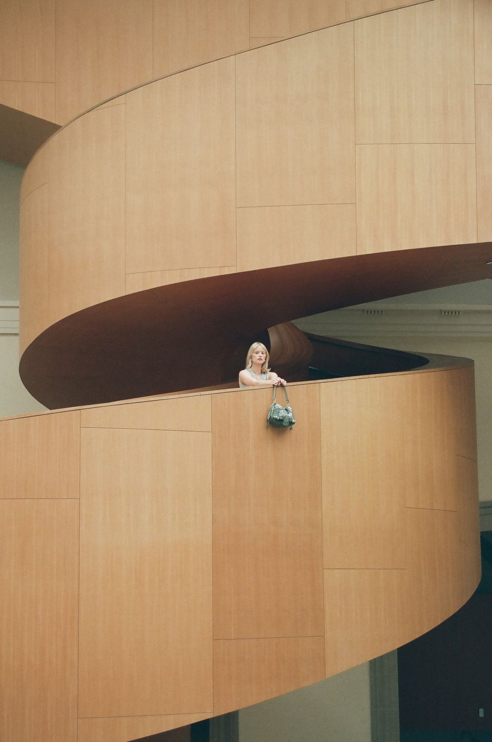 Modern architectural detail of curved wooden paneled walls in an interior space.