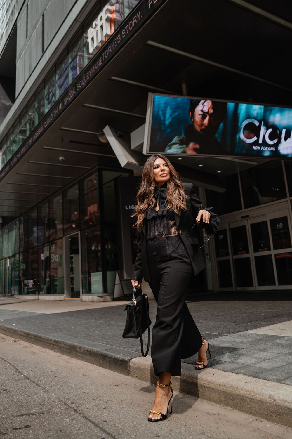 Dynamic movement sequence outside a modern building at night wearing dark clothing.