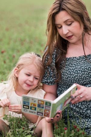 Sharing a special moment while looking at photos together outdoors.