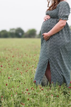 A series of photos showing a flowy green floral dress in a wildflower meadow with red poppies.