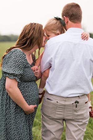 Intimate family portrait session in a natural outdoor setting.