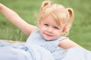 A lighthearted moment captured on a sunny day against lush green grass.
