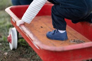 A close-up view of white sneakers stepping on a red surface in a sequence of motion shots.