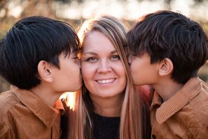 A romantic autumn photoshoot with a couple embracing in warm tones and natural lighting.