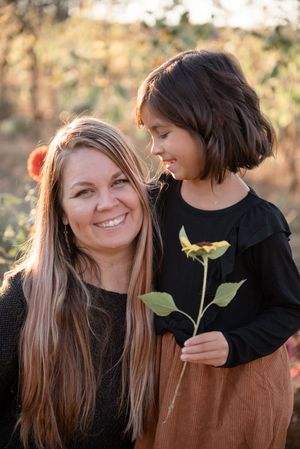 A heartwarming outdoor photoshoot showing tender moments between two people in autumn lighting.