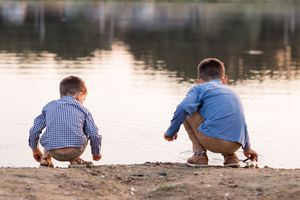 A series of photos shows someone in blue and checkered clothing crouching by a lake or pond's edge.