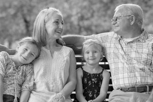 A black and white collage of candid family moments showing joyful interactions between loved ones outdoors.