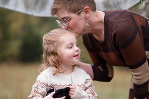 A tender outdoor family moment captured in a series of intimate interactions in a natural setting.