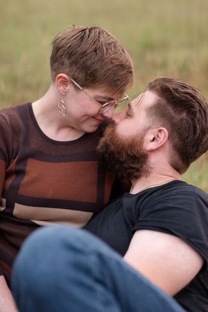 Intimate close-up of a couple sharing a tender moment outdoors.