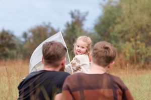 A series of candid family photographs taken in a rustic outdoor setting during golden hour.