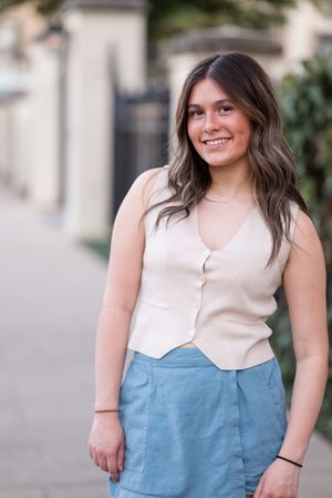 Fashion photo series showing cream top and light blue skirt against neutral urban background.