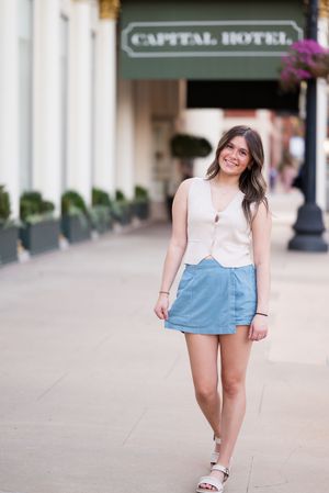 Summer outfit with light top and denim shorts photographed outside Capital Hotel.