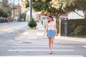 Urban street scene with sunlit sidewalks and buildings on a bright summer day.