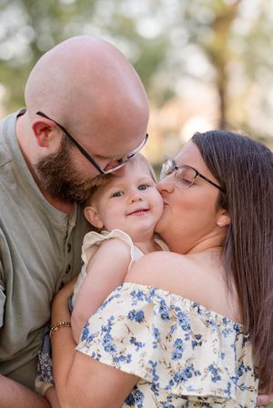 A series of intimate outdoor family portraits showing tender moments and kisses in warm natural lighting.