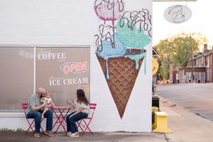 A collection of ice cream shop storefront signs and cone decorations arranged in a horizontal collage.