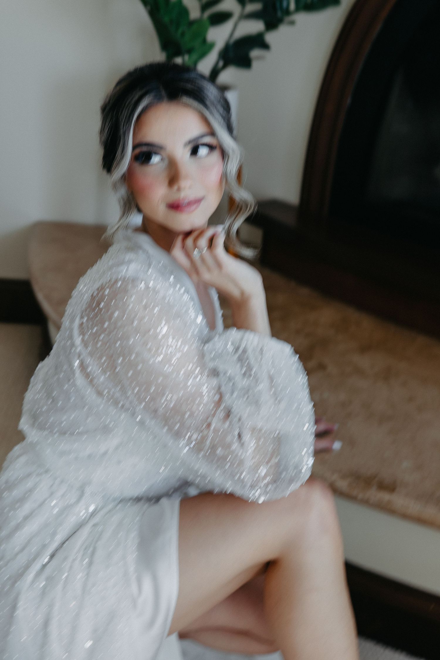 Glamorous bridal portrait featuring sparkly white robe and elegant styling.