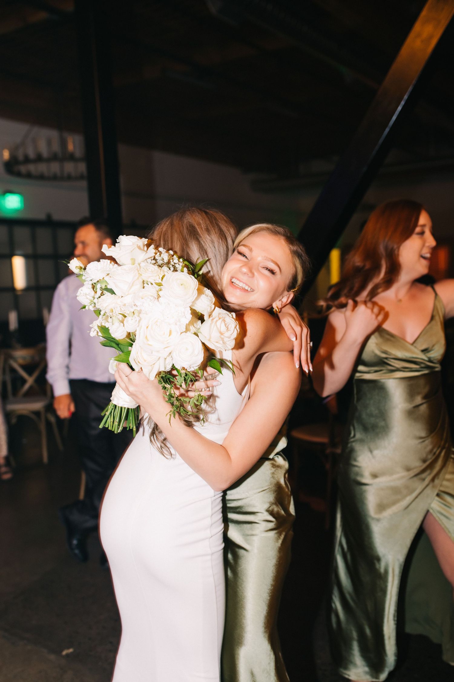 Wedding celebration featuring elegant formal attire and a stunning white floral bouquet.