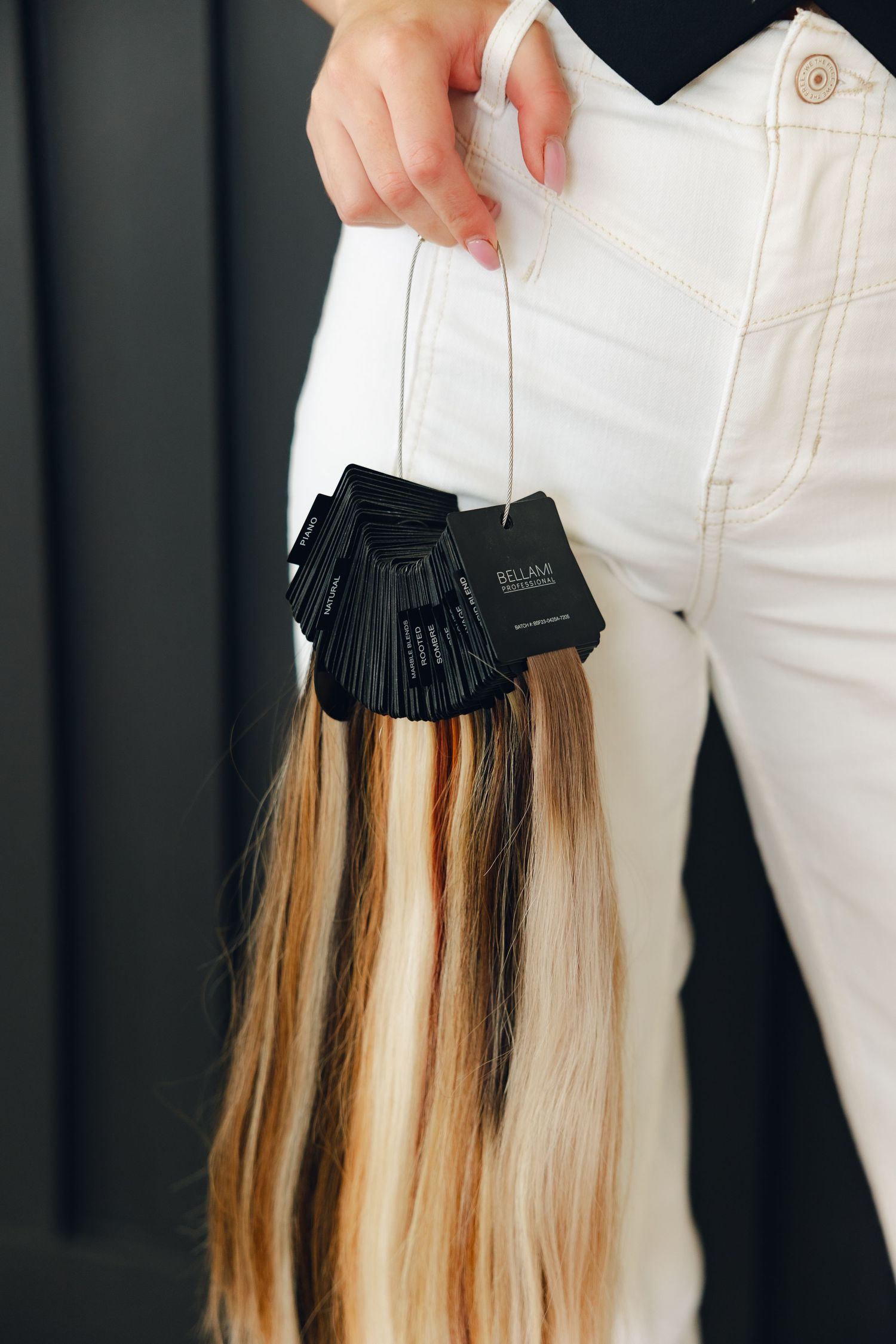 Black clip-in hair extensions with blonde highlights shown being attached to natural hair in a step-by-step sequence.