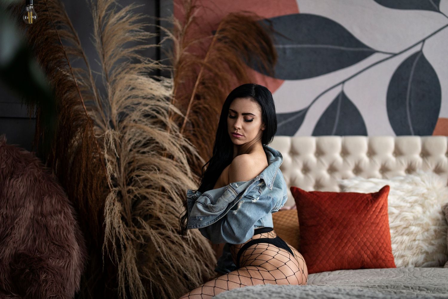 Artistic portrait with pampas grass decor and modern leaf wall art.