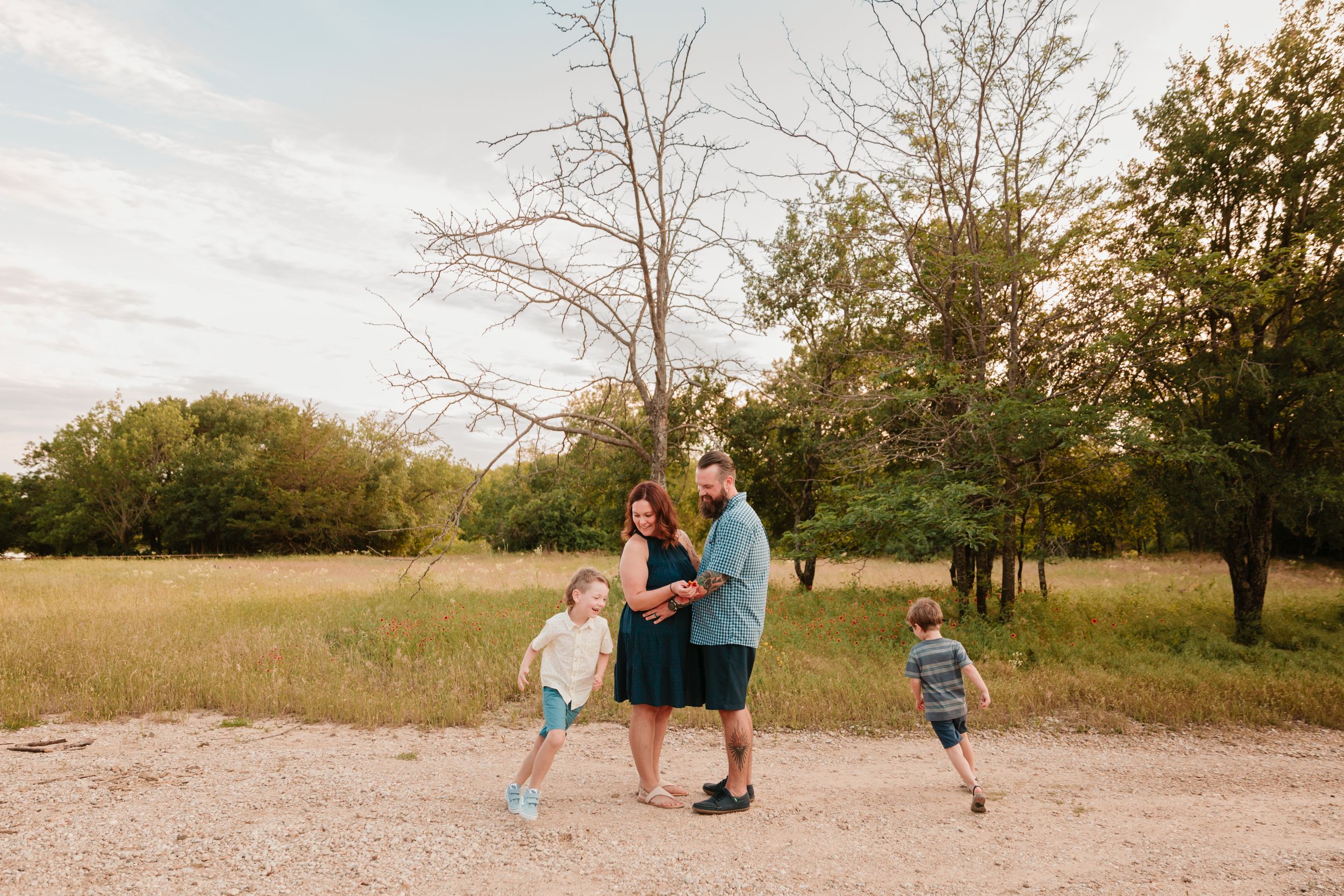 Active family enjoying time together on a nature path during sunset.