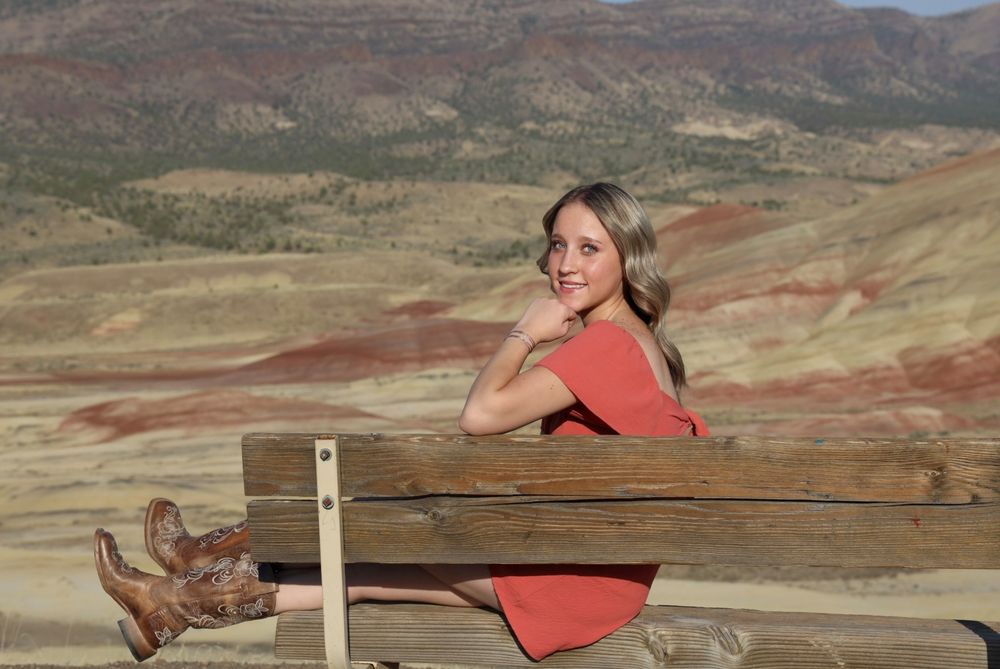 Scenic views of the colorful Painted Hills in Oregon with a wooden observation deck overlooking the landscape.