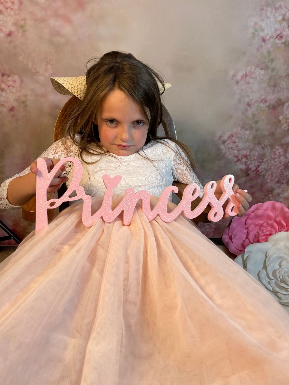 A pink tulle dress with lace details creates a dreamy princess-like effect in a series of soft-focus photos.