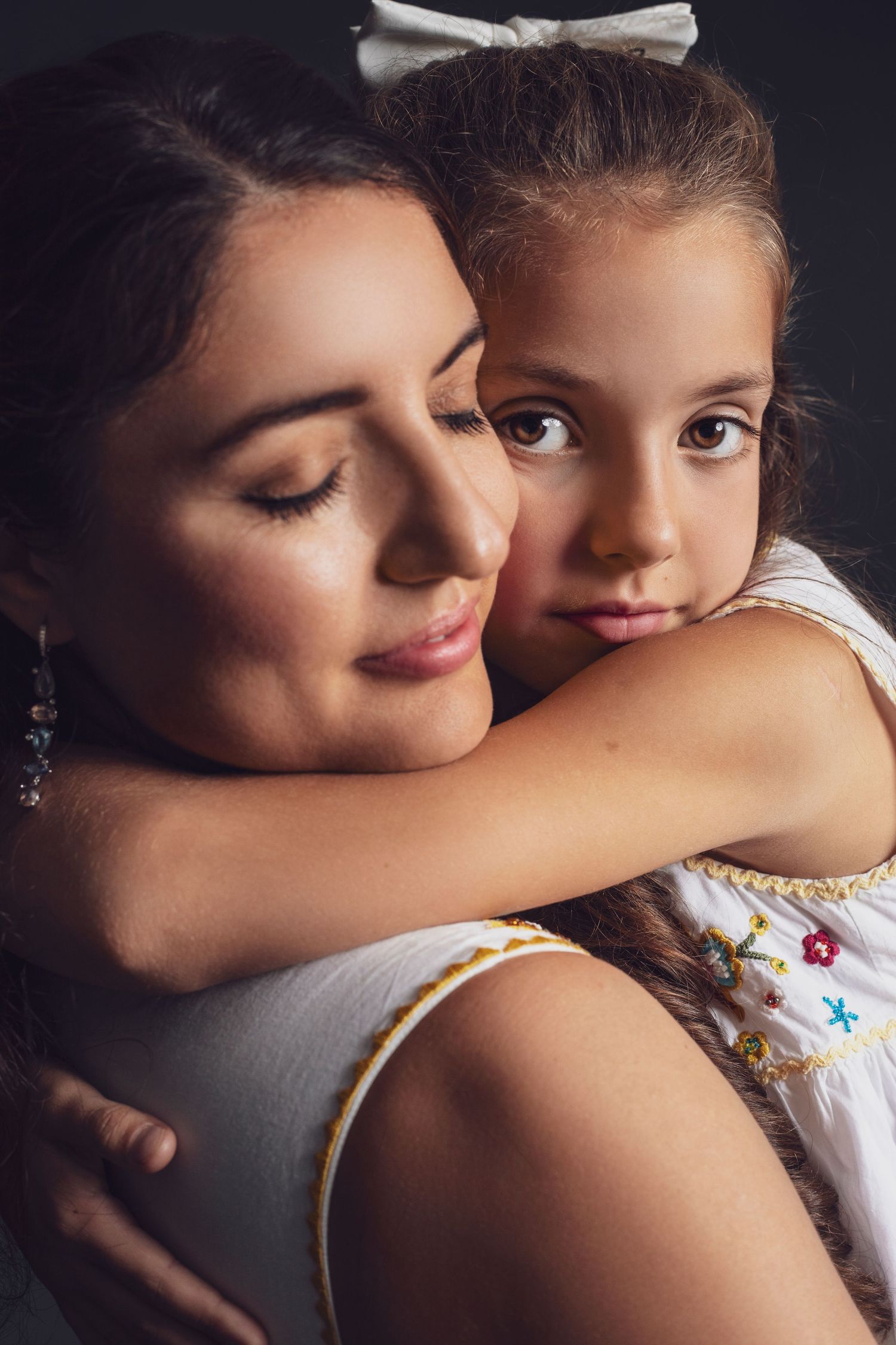 Intimate black and white portrait series showing tender moments between parent and child.