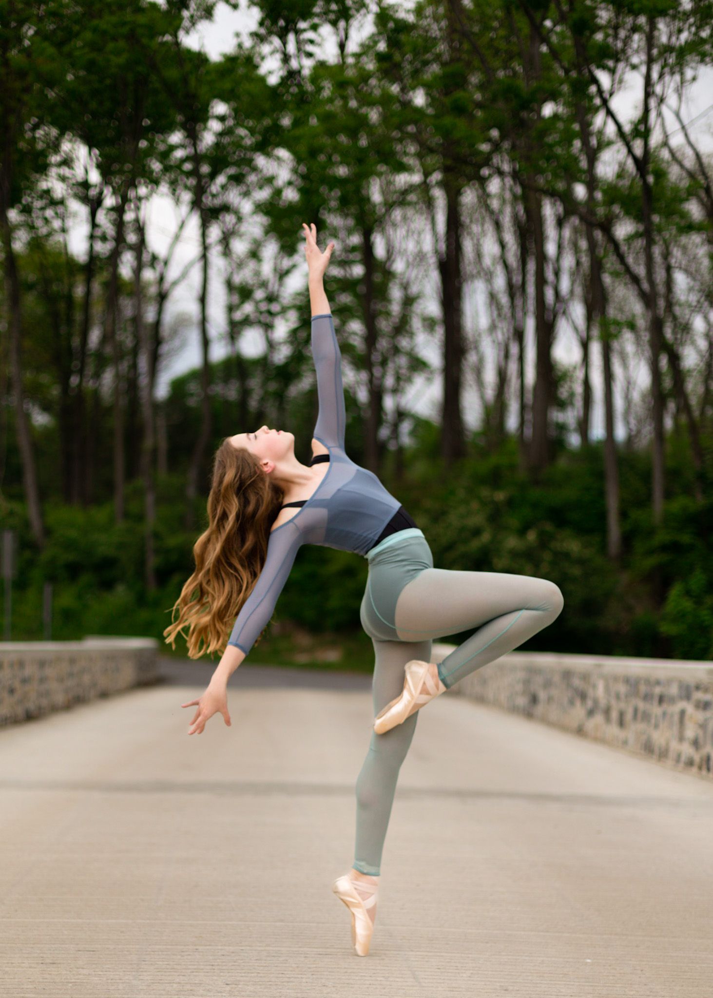 Ballet dancer arching back on pointe on a Mechanicsburg bridge