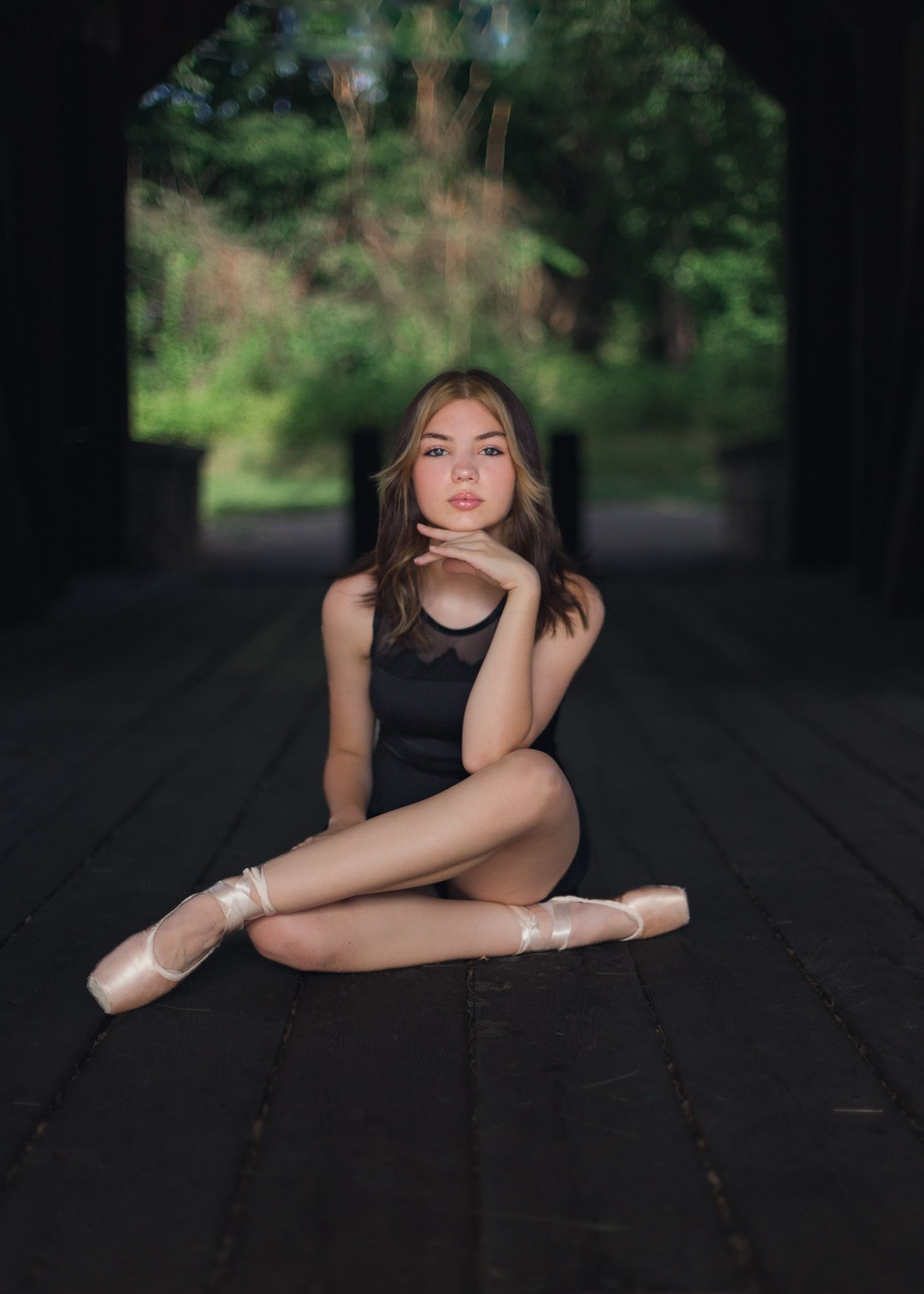 Ballet dancer seated on pointe in a rustic pavilion in Mechanicsburg