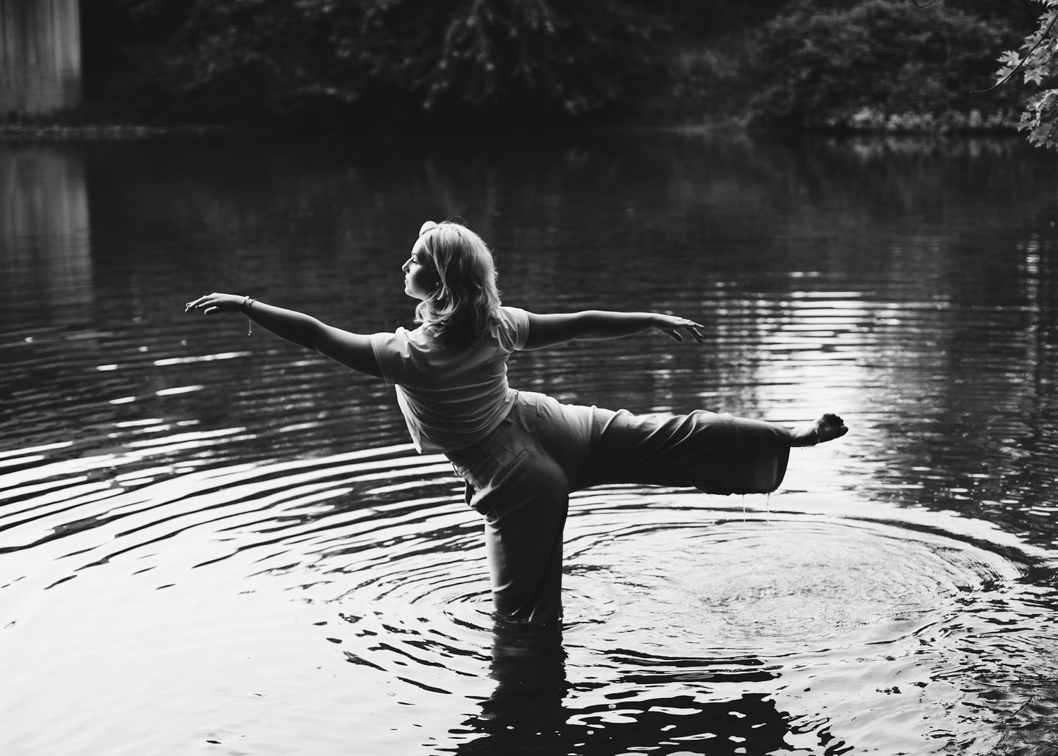 Black and white dancer in arabesque in a creek near Carlisle