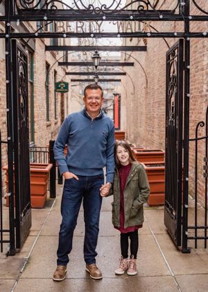 Downtown setting with rout iron arches makes a perfect setting for family photos.