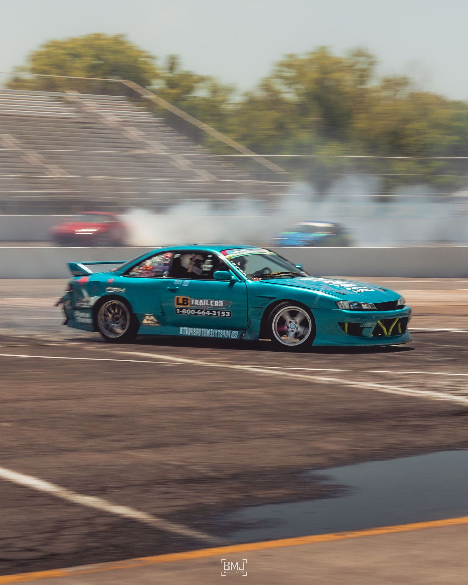 A blue drift car at a drift event at langley speedway in hampton VA